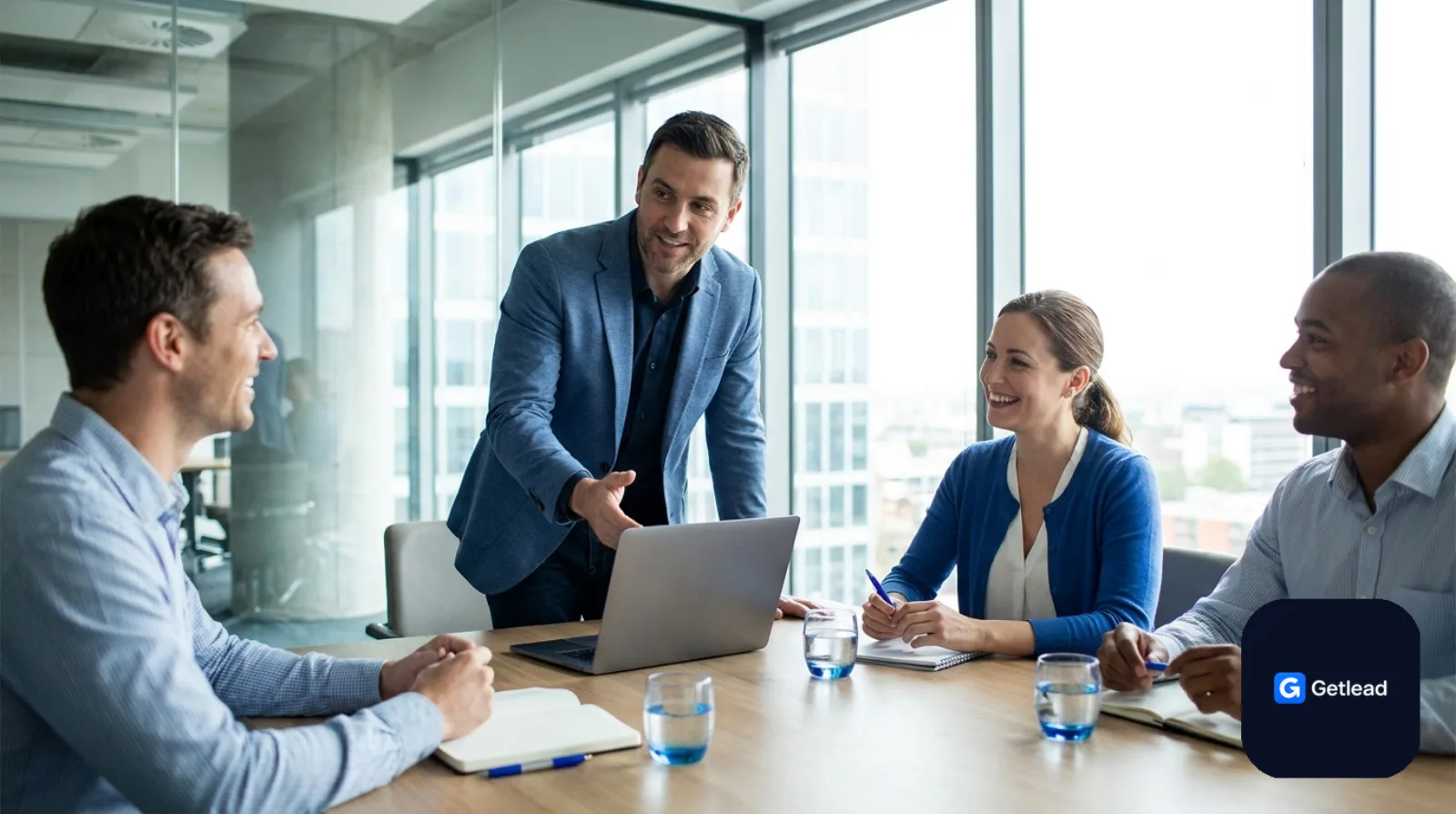 IT consultant presenting to a business team in a glass meeting room