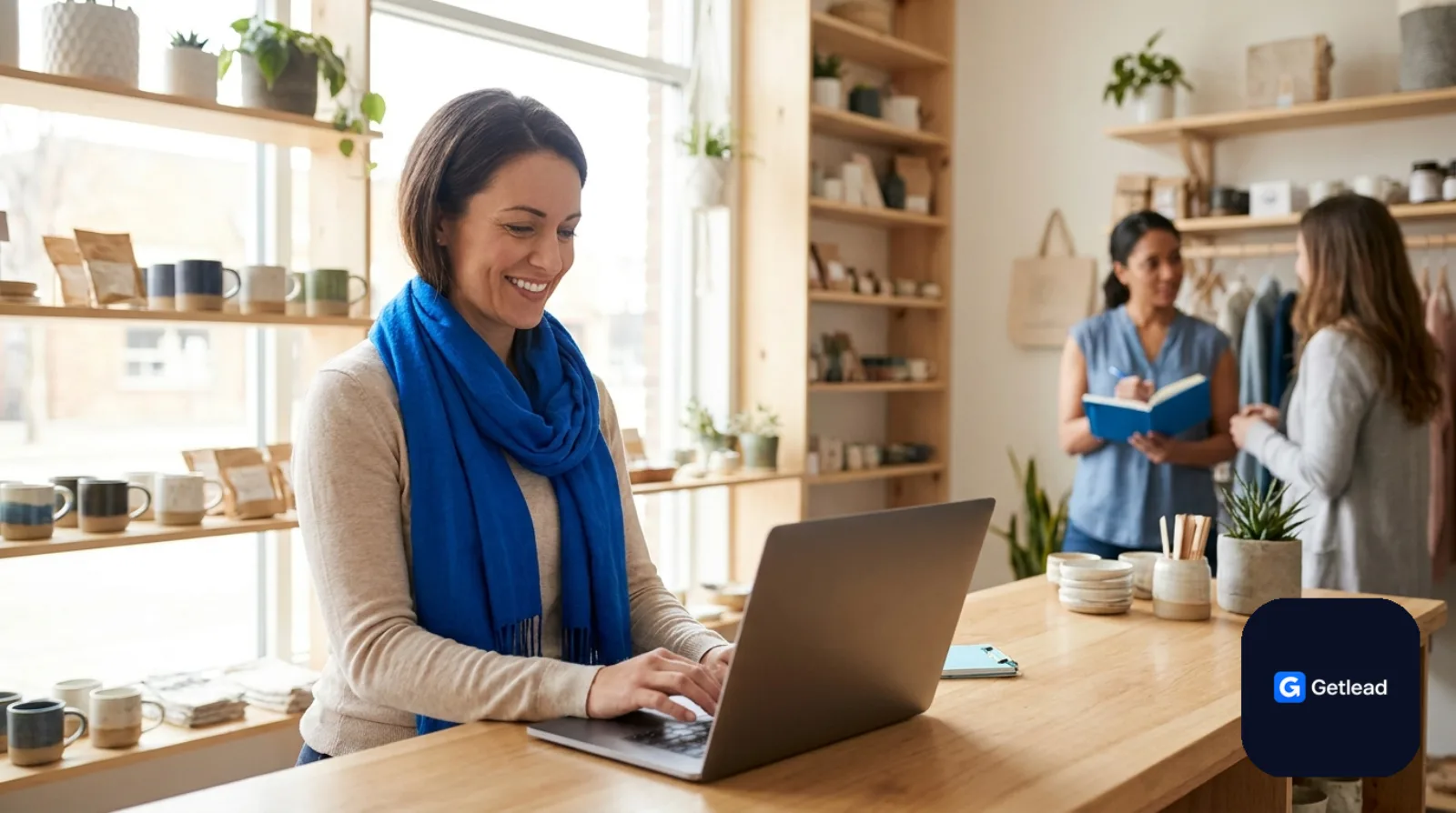 Small business owner working on a laptop at a boutique shop counter